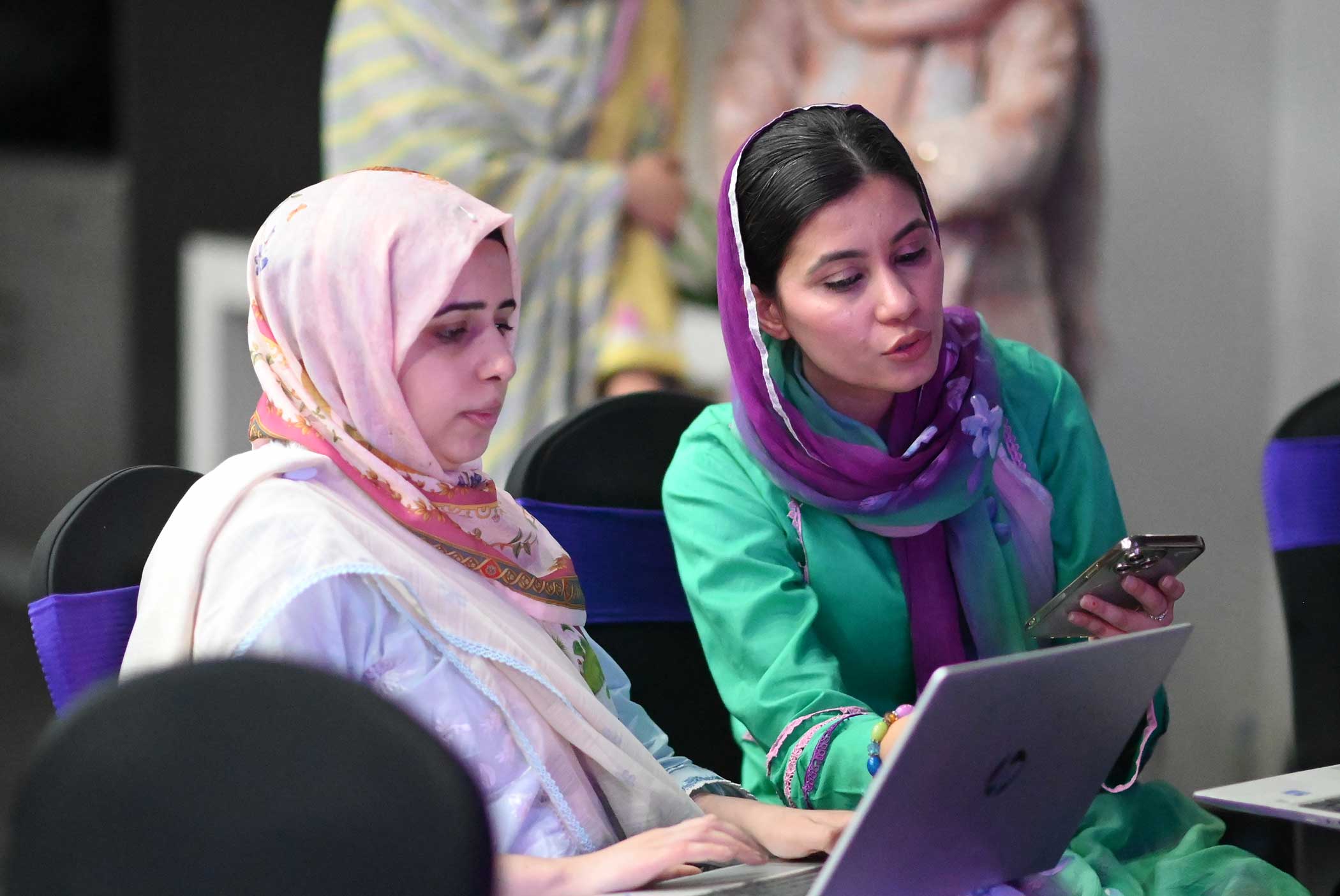 MMBL senior leaders helping each other with AI prompts during Think FRST workshop.